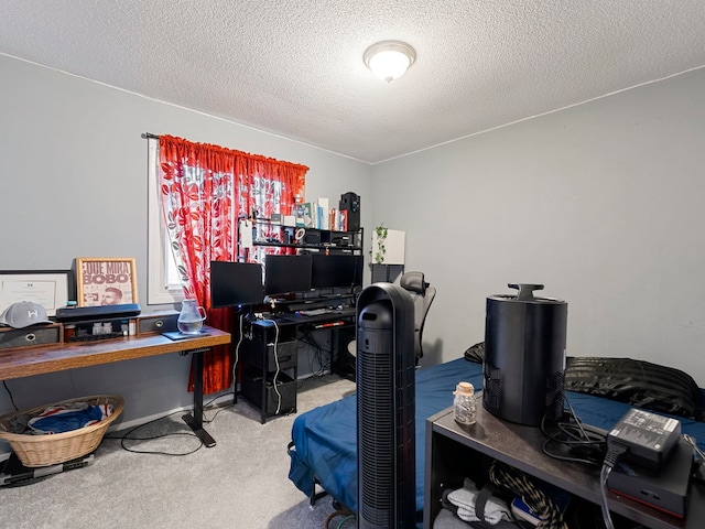 home office featuring carpet floors and a textured ceiling