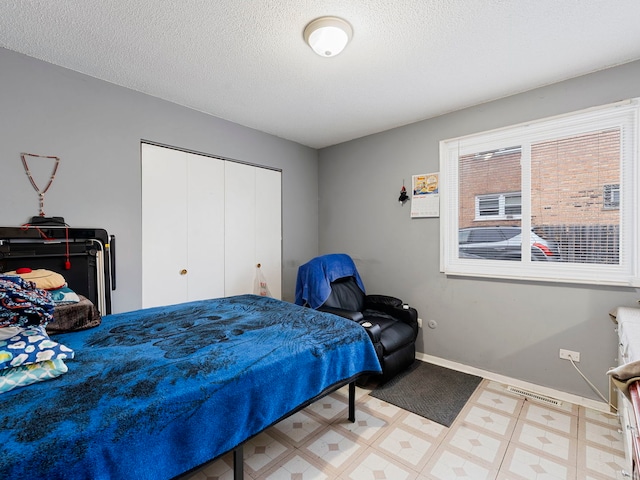 bedroom featuring a closet and a textured ceiling