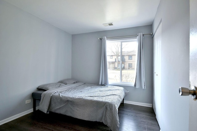 bedroom with dark hardwood / wood-style flooring