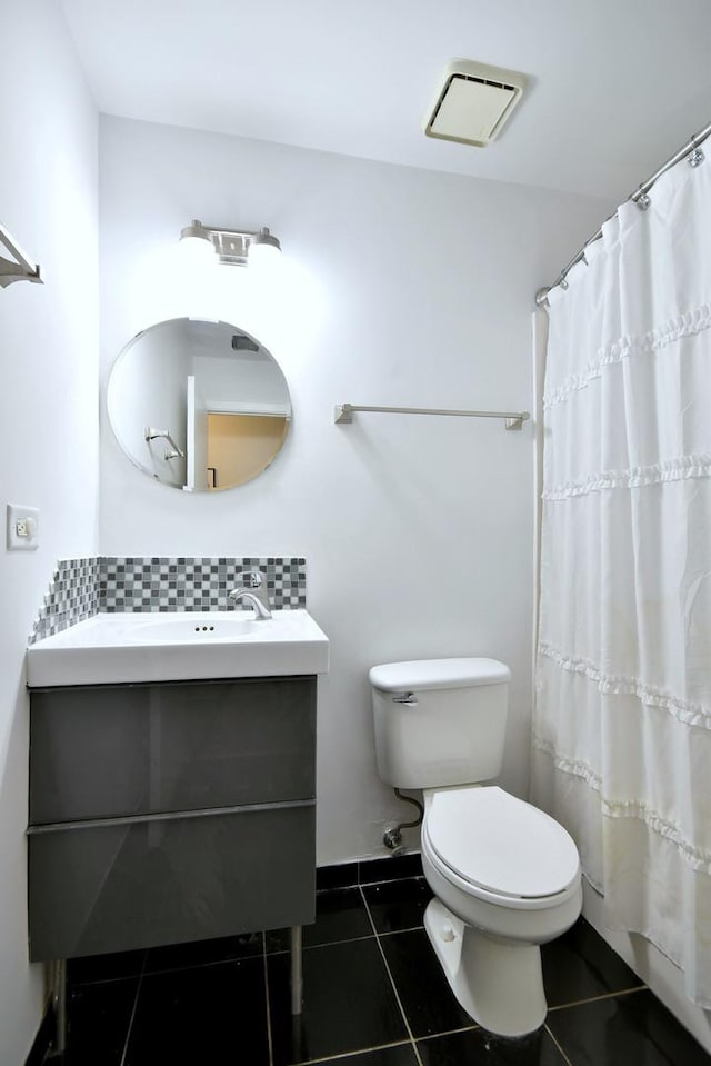 bathroom featuring vanity, toilet, tile patterned flooring, and backsplash