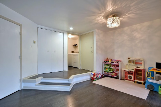 recreation room featuring washer and dryer and dark wood-type flooring