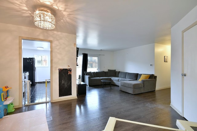 living room featuring dark wood-type flooring and a chandelier