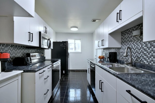 kitchen with dark tile patterned floors, sink, white cabinets, and black appliances