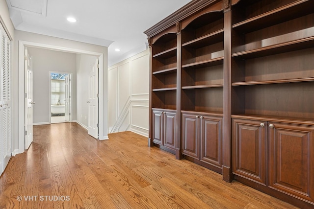 hallway featuring light wood-style flooring, recessed lighting, and baseboards