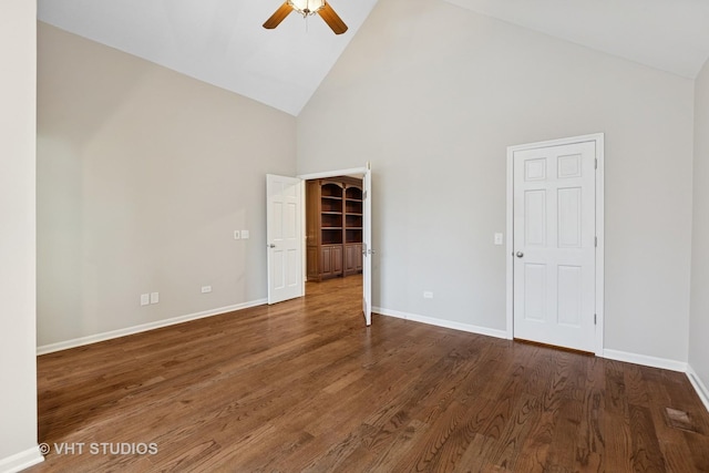 unfurnished room with a ceiling fan, wood finished floors, baseboards, and high vaulted ceiling