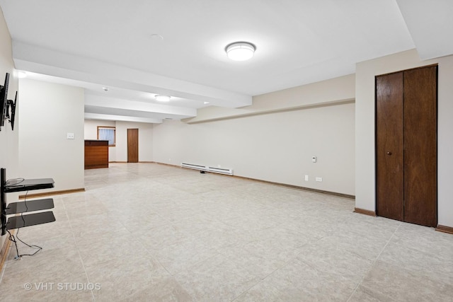 finished basement with a baseboard radiator and baseboards