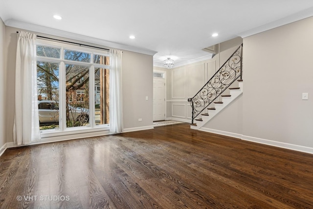 interior space featuring baseboards, stairway, ornamental molding, recessed lighting, and wood finished floors