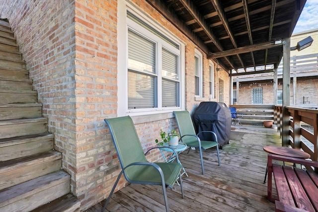 wooden terrace featuring a grill