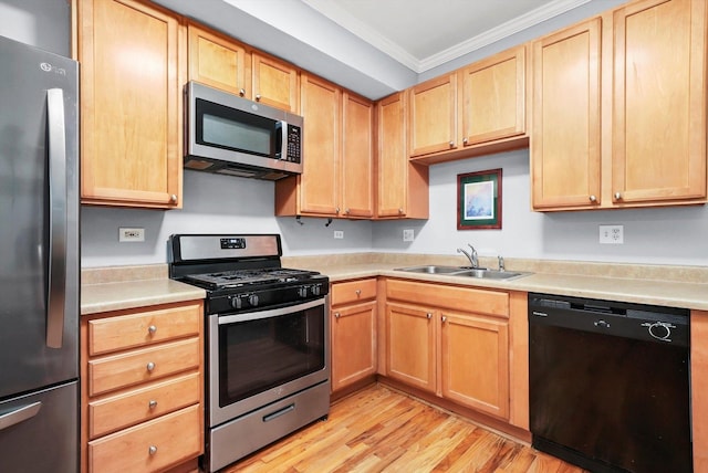 kitchen featuring light brown cabinetry, sink, crown molding, light wood-type flooring, and appliances with stainless steel finishes