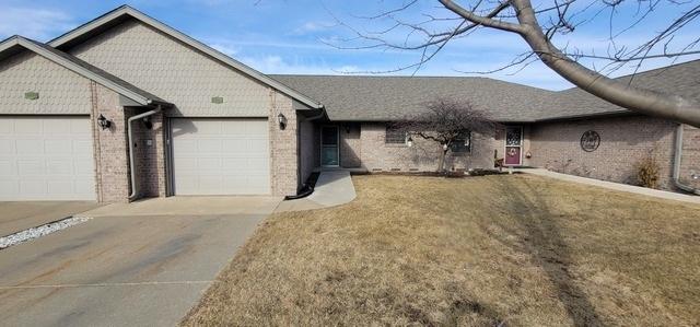 ranch-style house featuring a garage and a front yard