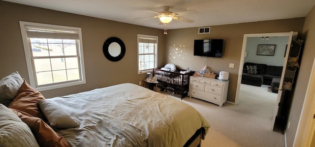 bedroom featuring light carpet and ceiling fan