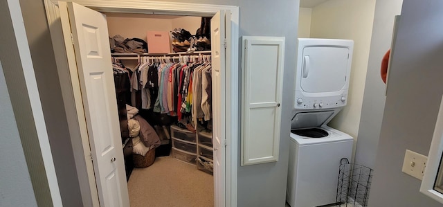 clothes washing area with stacked washing maching and dryer