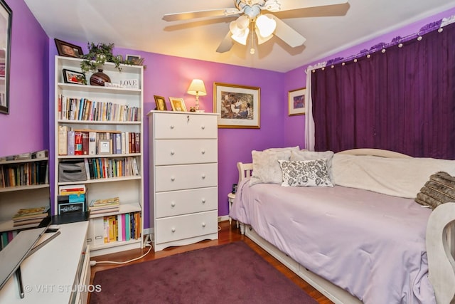 bedroom with ceiling fan and dark hardwood / wood-style flooring