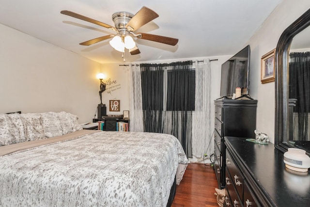 bedroom featuring ceiling fan and dark hardwood / wood-style flooring