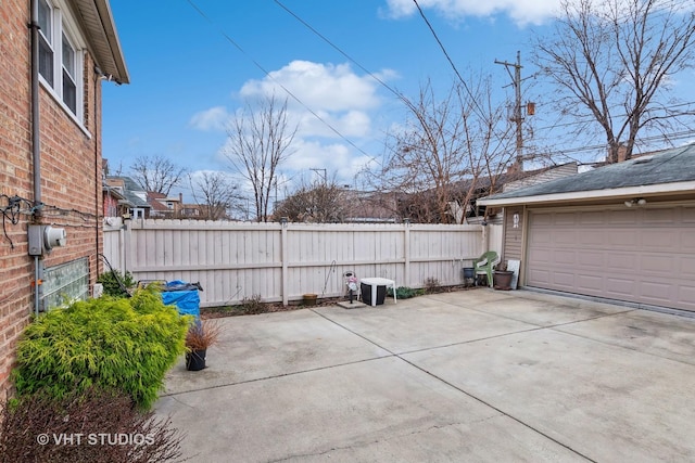 view of patio / terrace with a garage and an outdoor structure