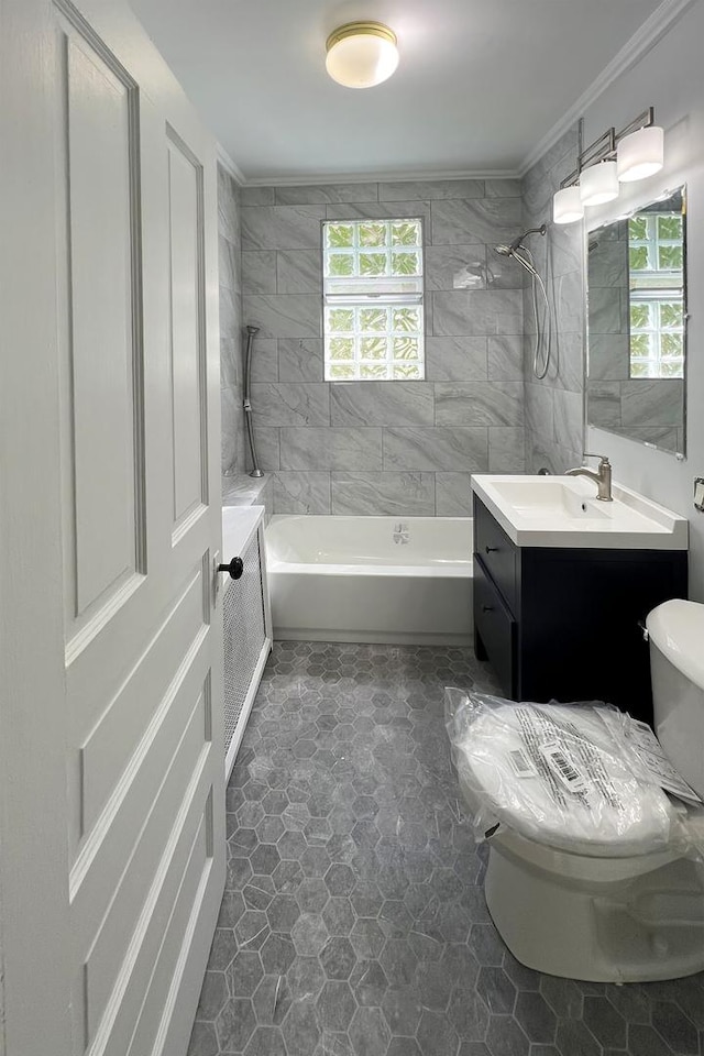 full bathroom with tiled shower / bath, vanity, and toilet