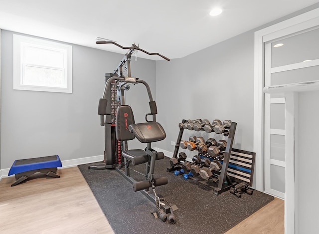 exercise room with hardwood / wood-style flooring