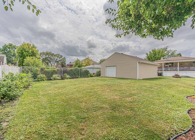 view of yard featuring a garage and an outdoor structure