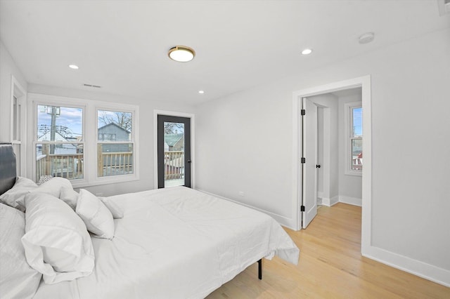 bedroom with baseboards, light wood finished floors, access to exterior, and recessed lighting