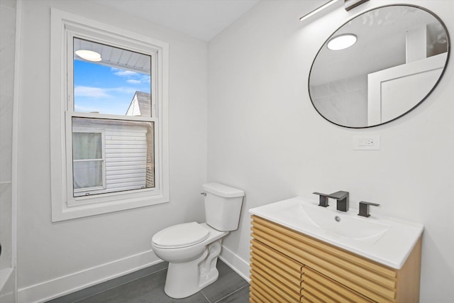 bathroom with toilet, baseboards, and vanity