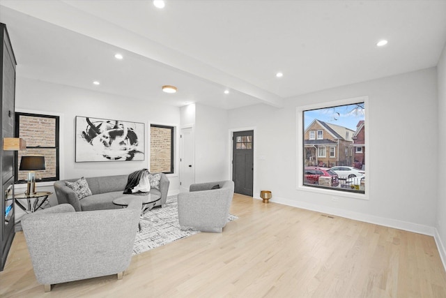 living area featuring recessed lighting, baseboards, and light wood finished floors