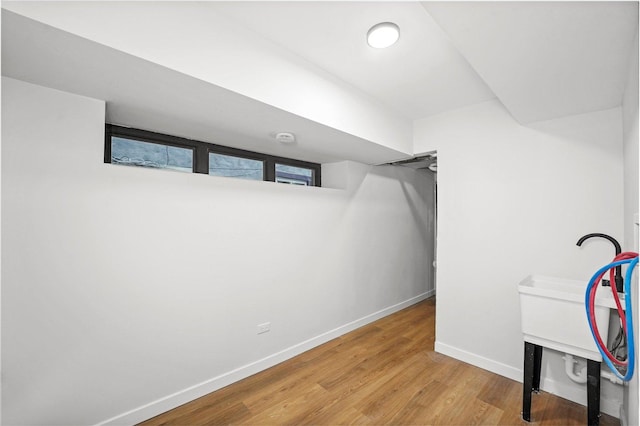 interior space with wood finished floors and baseboards