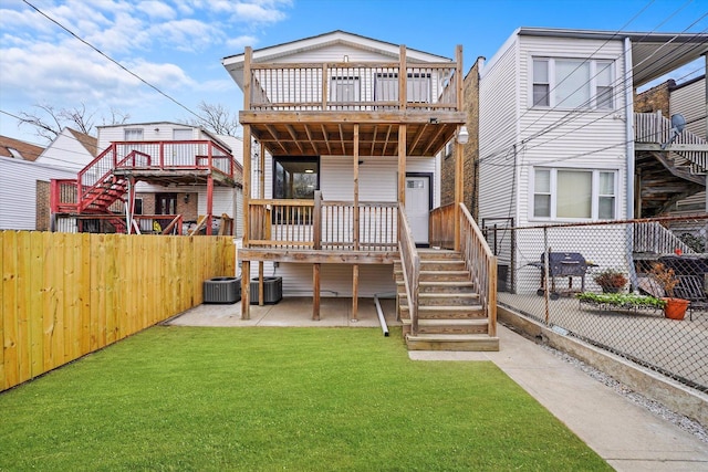 back of property featuring a patio area, a yard, a fenced backyard, and a wooden deck