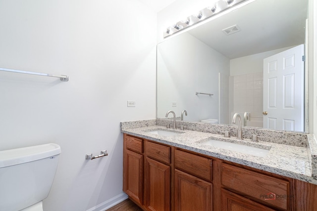 bathroom featuring vanity and toilet