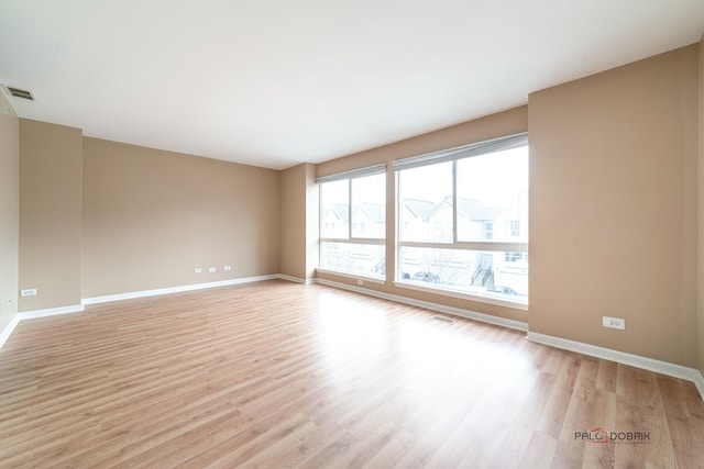 unfurnished room with light wood-type flooring