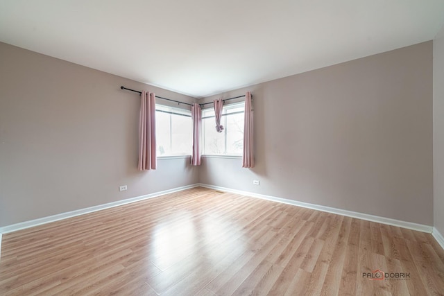 unfurnished room with light hardwood / wood-style floors