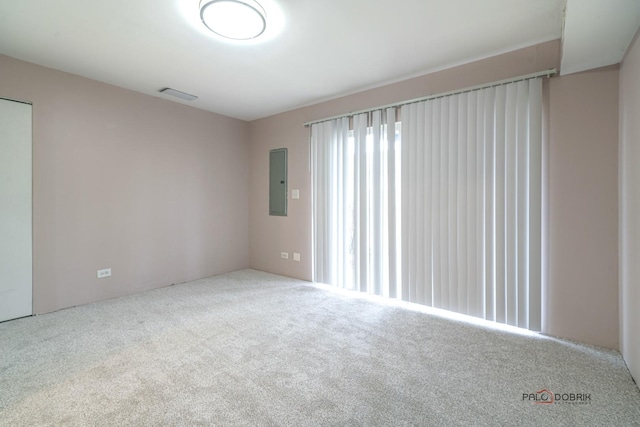 carpeted empty room featuring electric panel