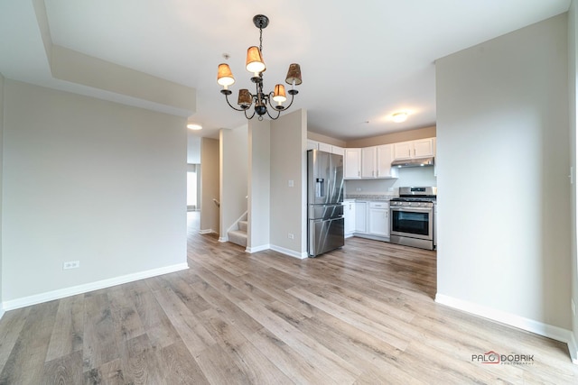 kitchen with white cabinetry, an inviting chandelier, light hardwood / wood-style flooring, appliances with stainless steel finishes, and pendant lighting