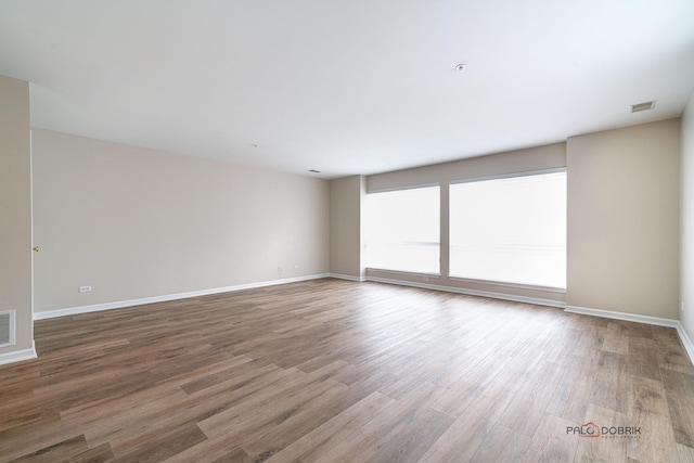 spare room with hardwood / wood-style flooring