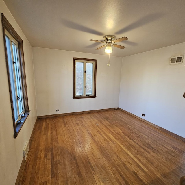 spare room with hardwood / wood-style flooring and ceiling fan