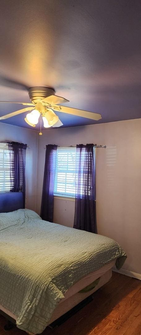 bedroom with hardwood / wood-style flooring and ceiling fan