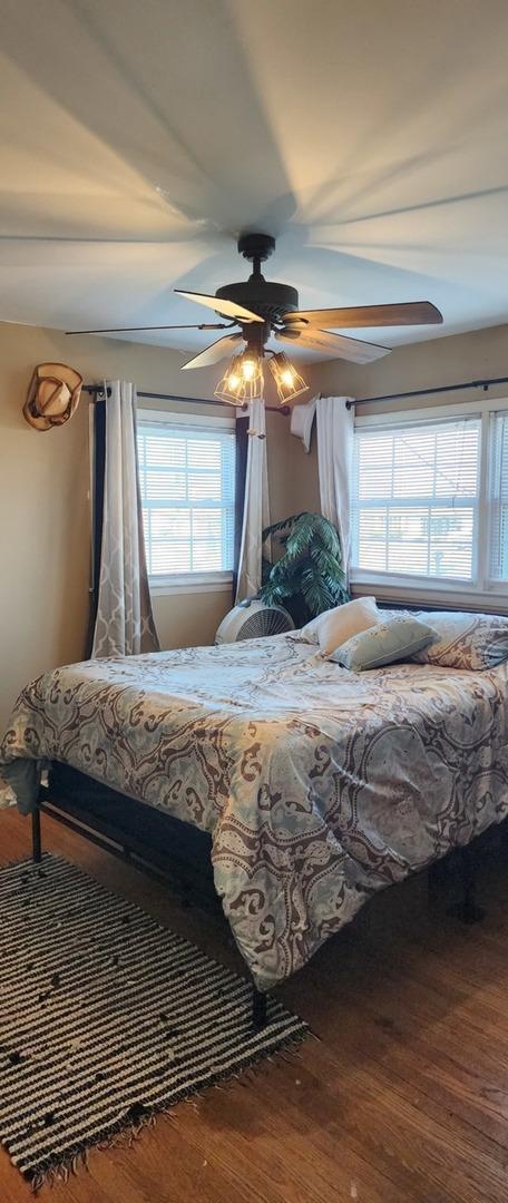 bedroom featuring ceiling fan and hardwood / wood-style floors