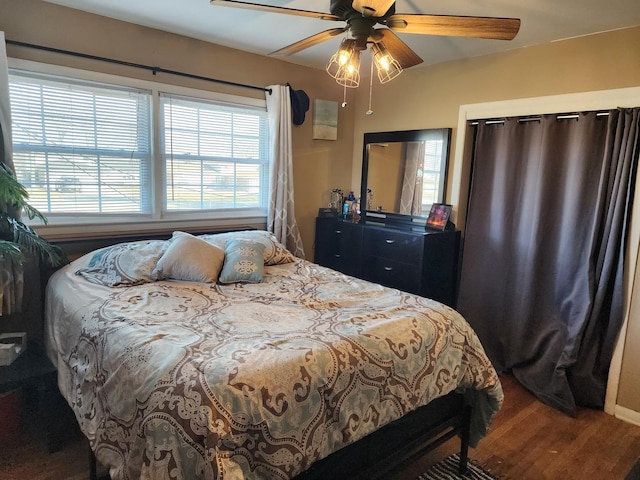 bedroom with hardwood / wood-style flooring and ceiling fan