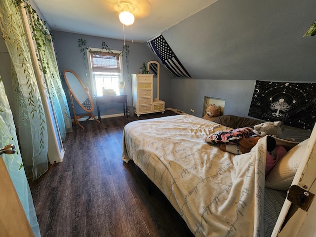 bedroom featuring lofted ceiling and dark wood-type flooring