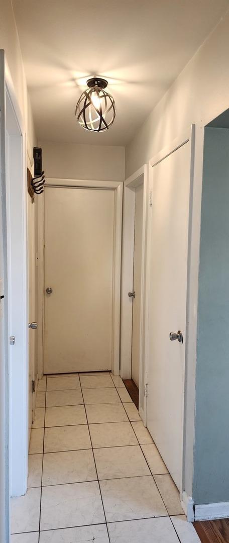 corridor with light tile patterned flooring