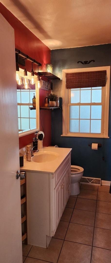 bathroom featuring vanity, tile patterned floors, and toilet