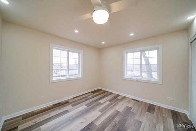 unfurnished room with ceiling fan, a healthy amount of sunlight, and light hardwood / wood-style flooring