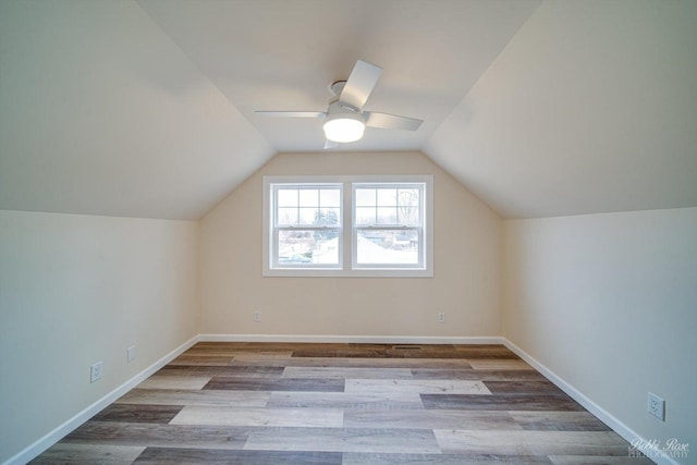 additional living space with lofted ceiling, light hardwood / wood-style flooring, and ceiling fan