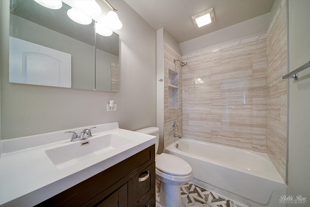 full bathroom featuring tiled shower / bath, vanity, and toilet