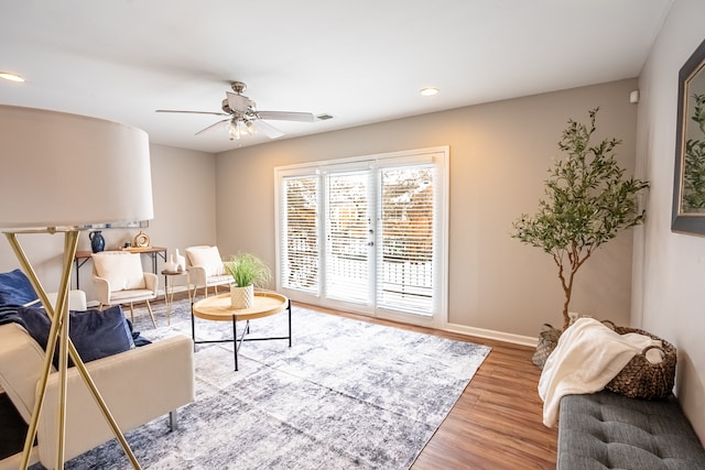 living room with ceiling fan and light wood-type flooring