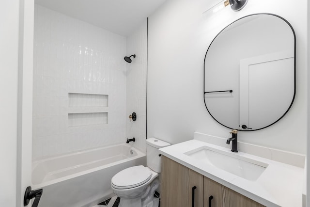 full bathroom with tiled shower / bath, vanity, and toilet