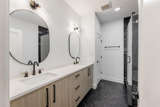 bathroom with vanity and a shower with door