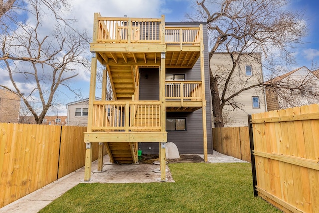 rear view of house with a patio and a lawn