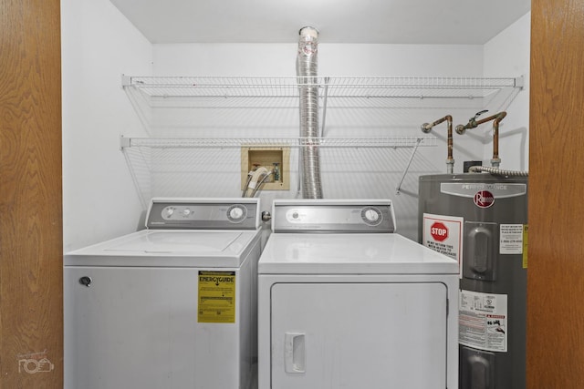 clothes washing area featuring washing machine and dryer and electric water heater