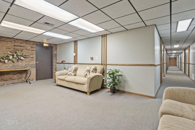 carpeted living room featuring a paneled ceiling and a fireplace