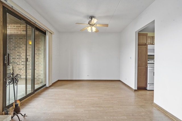 empty room with ceiling fan and light hardwood / wood-style floors